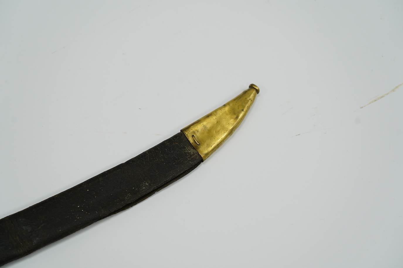 A French briquet cast D-shaped brass hilt in its brass mounted leather scabbard, blade 59.5cm. Condition - fair, blade heavily cleaned